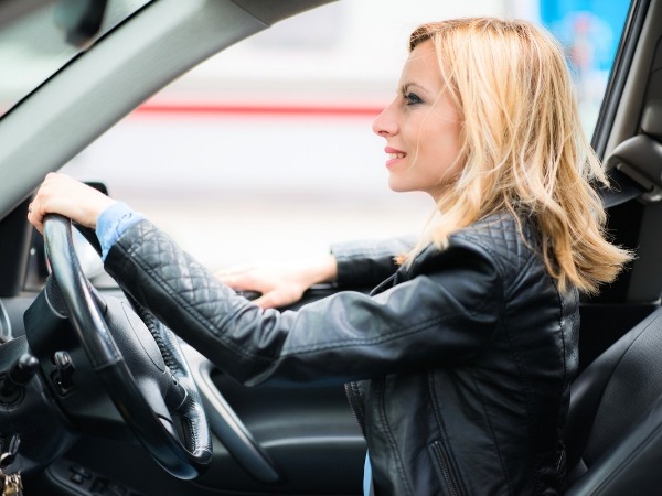Woman Driving a Black Car