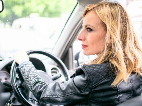 Woman Driving a Black Car