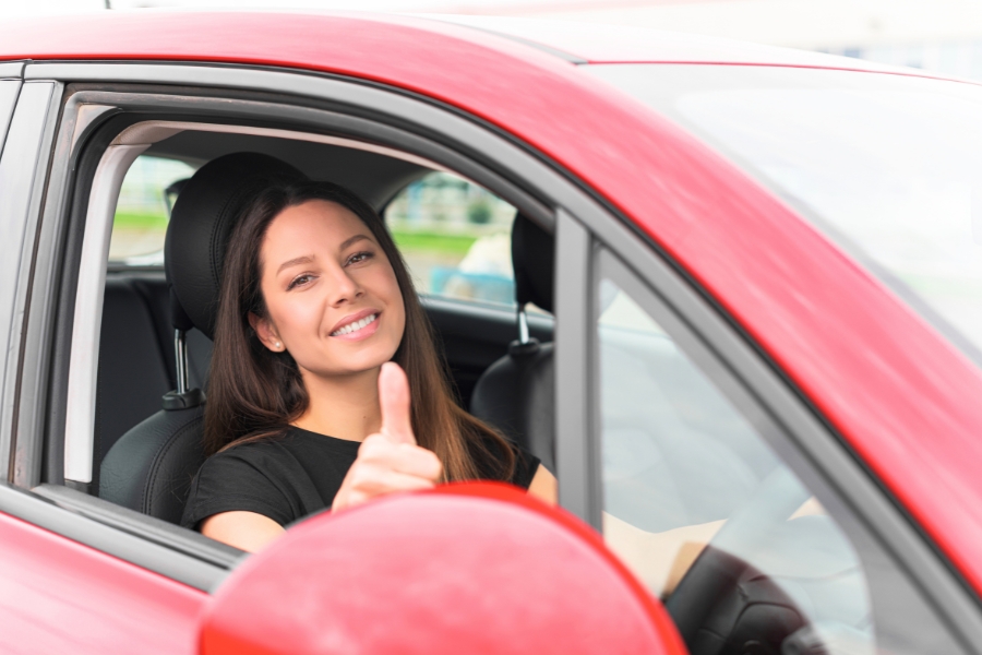 Woman Driving a Red Car