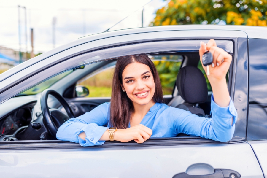Woman Driving a Silver Car