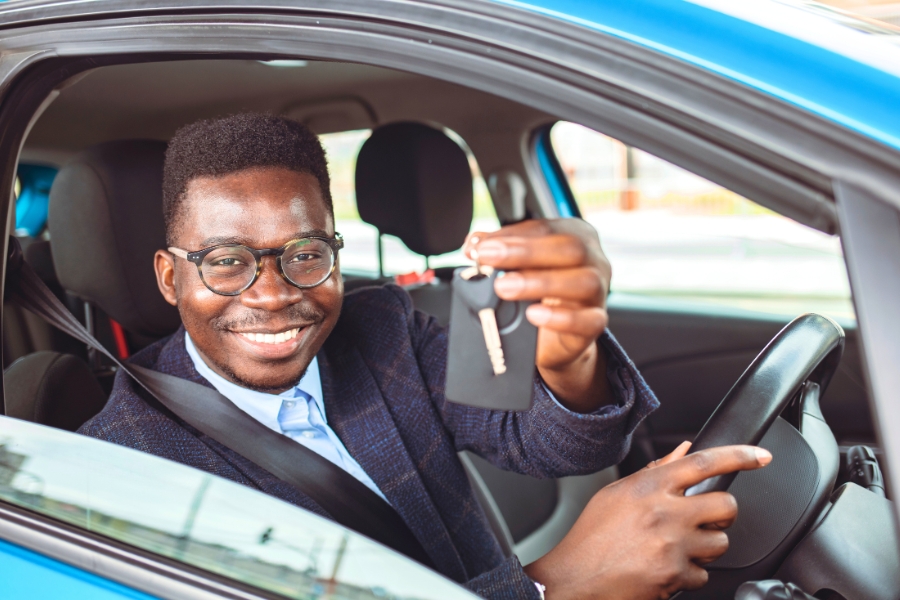 Man Driving a Blue Car