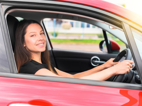 Woman Driving a Red Car