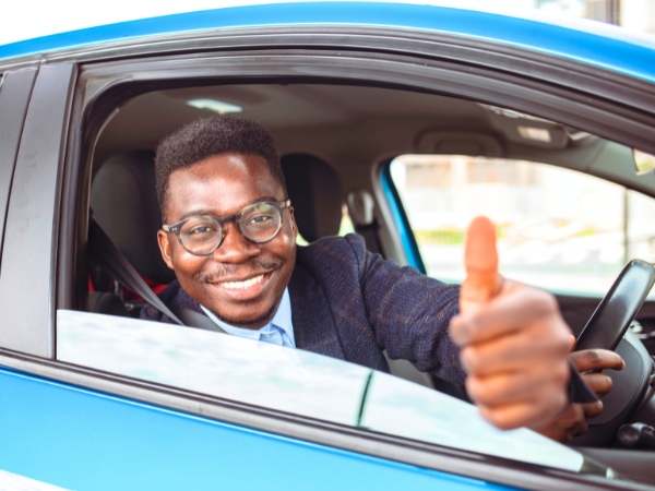 Man Driving a Blue Car