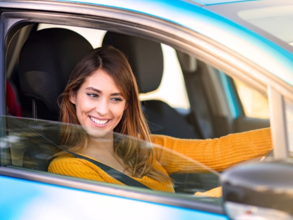 Woman Driving a Blue Car